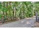 Gated entrance and paved driveway lined with trees and lush landscaping at 183 Parsons Rd, Longwood, FL 32779