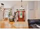 Inviting foyer with a decorative front door, chandelier, and views of the living room with hardwood floors at 183 Parsons Rd, Longwood, FL 32779