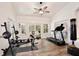 Dedicated exercise room with workout equipment, ceiling fan, and natural light from surrounding windows at 183 Parsons Rd, Longwood, FL 32779