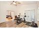 Home gym with exercise equipment, connecting to the main house with hardwood floors throughout at 183 Parsons Rd, Longwood, FL 32779