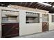 Well-maintained horse stalls featuring secure doors, concrete walls, and ample lighting for comfortable animal housing at 183 Parsons Rd, Longwood, FL 32779