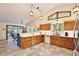 Spacious kitchen with granite countertops, wood cabinets, stainless fridge, and tile flooring at 183 Parsons Rd, Longwood, FL 32779