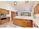 Kitchen boasts granite countertops, wood cabinets, stainless appliances, and tile flooring at 183 Parsons Rd, Longwood, FL 32779