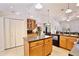 Kitchen with an island, tile floors, ample cabinet space, and a view of the adjacent living areas at 183 Parsons Rd, Longwood, FL 32779