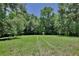 Tranquil land with lush grass and mature trees creates a serene and private outdoor space at 183 Parsons Rd, Longwood, FL 32779