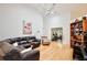 Open living room with vaulted ceilings, hardwood floors, large sectional sofa, and view of the exercise room at 183 Parsons Rd, Longwood, FL 32779
