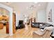 Spacious living room with hardwood floors, a large sectional sofa, and an open view to the kitchen area at 183 Parsons Rd, Longwood, FL 32779