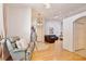 Bright living room featuring hardwood floors, high ceilings, a coat rack, and a comfortable green armchair at 183 Parsons Rd, Longwood, FL 32779