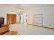 Spacious living room with neutral carpet, ceiling fan, wood-paneled closet and metal shelving at 183 Parsons Rd, Longwood, FL 32779