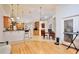 Open-concept living space with hardwood floors connecting the kitchen, dining, and living room areas at 183 Parsons Rd, Longwood, FL 32779
