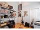 Creative home office with shelves displaying movies and media near guitars and sound equipment at 183 Parsons Rd, Longwood, FL 32779