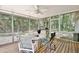 Relaxing screened-in porch with ceiling fan and outdoor seating overlooking a wooded backyard at 183 Parsons Rd, Longwood, FL 32779