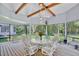 Relaxing screened porch with seating, wooden floors, natural light, and view of the garden at 183 Parsons Rd, Longwood, FL 32779