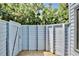 Outdoor shower with privacy fence, wooden floors, and lush green trees above at 183 Parsons Rd, Longwood, FL 32779