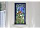 Close up of bathroom stained glass window featuring a regal peacock and leafy floral border at 183 Parsons Rd, Longwood, FL 32779