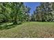 Large, well-maintained yard surrounded by mature trees, offering a private and serene outdoor space at 183 Parsons Rd, Longwood, FL 32779