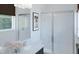 Modern bathroom with white vanity, granite countertop, glass enclosed shower, and frosted window at 1901 Fulfillment Dr, Kissimmee, FL 34744