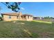 Expansive backyard with healthy green grass and a brick house backdrop at 2018 N Normandy Blvd, Deltona, FL 32725