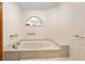 Bright bathroom featuring a soaking tub and unique window with decor at 2018 N Normandy Blvd, Deltona, FL 32725