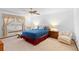 This primary bedroom has neutral carpet with a large window and ceiling fan at 2018 N Normandy Blvd, Deltona, FL 32725