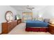 The bright bedroom features a ceiling fan, large windows with decorative curtains, and light-colored walls at 2018 N Normandy Blvd, Deltona, FL 32725