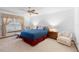This primary bedroom has neutral carpet with a large window, ceiling fan, and a sitting area at 2018 N Normandy Blvd, Deltona, FL 32725