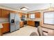A kitchen featuring stainless steel appliances, wooden cabinets, and tile flooring at 2018 N Normandy Blvd, Deltona, FL 32725