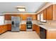A kitchen featuring stainless steel appliances, wooden cabinets, and tile flooring at 2018 N Normandy Blvd, Deltona, FL 32725
