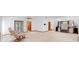 Expansive living room featuring neutral carpet, two recliners, and custom built-in shelving at 2018 N Normandy Blvd, Deltona, FL 32725