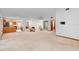 Spacious living area with view into dining and kitchen areas, featuring neutral carpet at 2018 N Normandy Blvd, Deltona, FL 32725