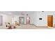 Open living room with neutral carpet, two recliners, and access to other rooms in the home at 2018 N Normandy Blvd, Deltona, FL 32725