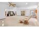 Spacious living room with a recliner, built-in shelving, a skylight, and sliding glass door to the outside at 2018 N Normandy Blvd, Deltona, FL 32725