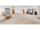 Large living room with neutral carpet, two recliners, and custom built-in shelving for storage at 2018 N Normandy Blvd, Deltona, FL 32725