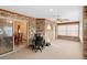Bright sun room featuring exposed brick walls and natural light with a ceiling fan and neutral carpet at 2018 N Normandy Blvd, Deltona, FL 32725