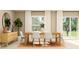 Dining room features a wooden table with seating and a sideboard with a circular mirror at 2025 Forage Dr, Kissimmee, FL 34746