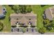 Aerial view of a condo building with parking and lush greenery at 2040 Royal Bay Blvd # 31, Kissimmee, FL 34746