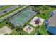 Overhead view of a tennis court and playground with surrounding greenery and buildings at 2040 Royal Bay Blvd # 31, Kissimmee, FL 34746