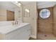 Well-lit bathroom featuring decorative tile, vanity, and a shower at 2040 Royal Bay Blvd # 31, Kissimmee, FL 34746