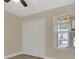Bright bedroom featuring a closet, window with a view, and tile flooring at 2040 Royal Bay Blvd # 31, Kissimmee, FL 34746