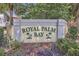 Welcoming community sign for Royal Palm Bay amidst lush landscaping and palm trees at 2040 Royal Bay Blvd # 31, Kissimmee, FL 34746