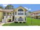 Charming yellow two-story condo featuring multiple windows and a well-maintained lawn at 2040 Royal Bay Blvd # 31, Kissimmee, FL 34746