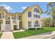 Charming yellow condo with well-manicured lawn and covered entryway at 2040 Royal Bay Blvd # 31, Kissimmee, FL 34746