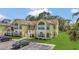Bright yellow condo building featuring balconies, manicured lawns and convenient parking at 2040 Royal Bay Blvd # 31, Kissimmee, FL 34746