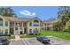 Exterior of a yellow two-story condo with private balconies and ample parking at 2040 Royal Bay Blvd # 31, Kissimmee, FL 34746