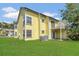 Bright yellow condo building with a charming balcony and well-maintained lawn at 2040 Royal Bay Blvd # 31, Kissimmee, FL 34746