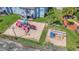 Aerial view of a colorful playground with slides and swings near residences at 2040 Royal Bay Blvd # 31, Kissimmee, FL 34746