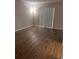 Neutral bedroom featuring wood-look floors, baseboards, and a large window at 2408 Swailes Dr # 6, Orlando, FL 32837
