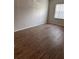 Bedroom with wood laminate floors and a window that provides natural light at 2408 Swailes Dr # 6, Orlando, FL 32837