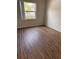 Cozy bedroom with wood-look flooring, a large window for natural light at 2408 Swailes Dr # 6, Orlando, FL 32837