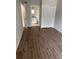 Bedroom with laminate flooring and a view into the bathroom and closet at 2408 Swailes Dr # 6, Orlando, FL 32837